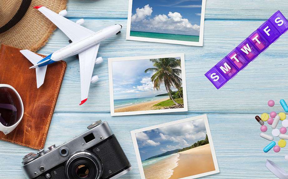 Travel vacation background concept with sun hat, camera, passport, airplane toy, weekend photos and essential medical items.