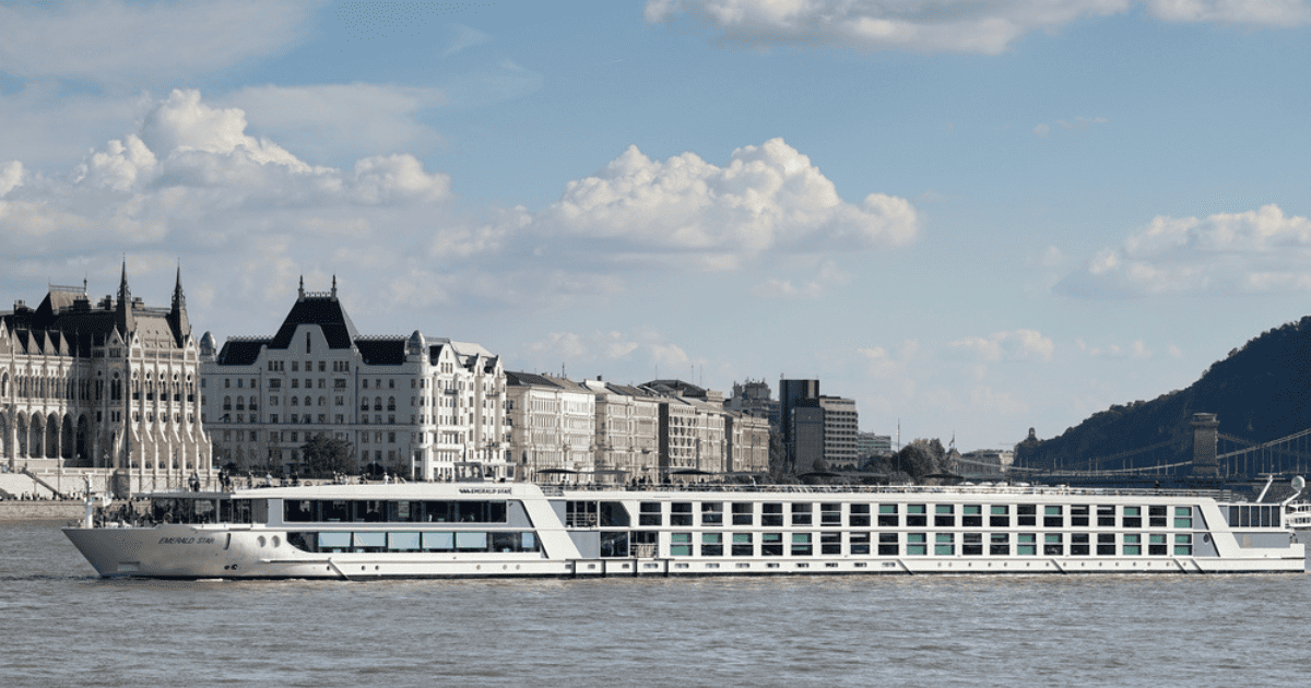 Scenic view of a luxury river cruise ship sailing on the Danube River, showcasing the beauty of European river cruising.