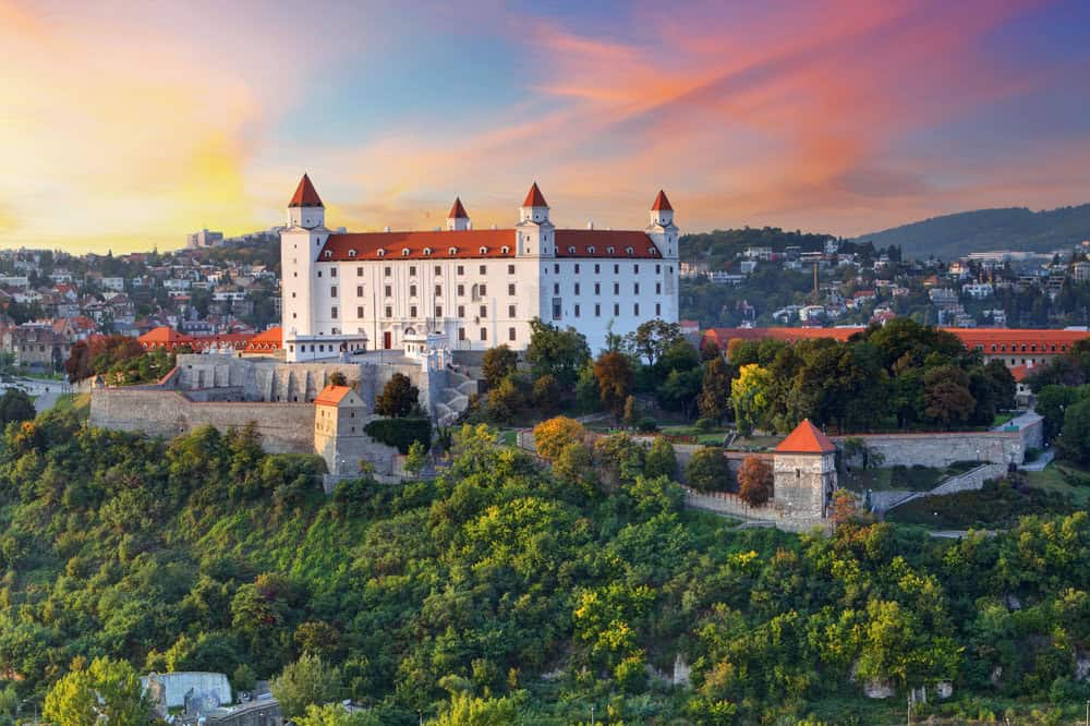 Bratislava Castle in Slovakia at sunset, overlooking the Danube River with stunning panoramic views of the city and surrounding hills.